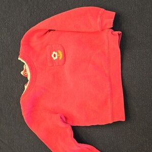 Mini Boden in pink sweatshirt with lace collar.